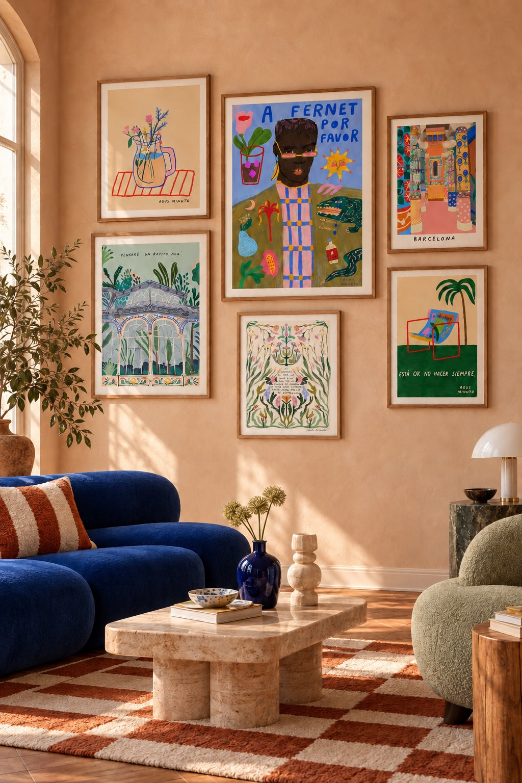 Six framed works by Agus Minuto in a sunlit room with a cobalt sofa