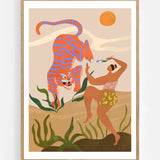 Dance With Me by Arty Guava – orange tiger with violet stripes beside a dancing woman and green leaves. Art print shown in a natural oak frame on a white wall.