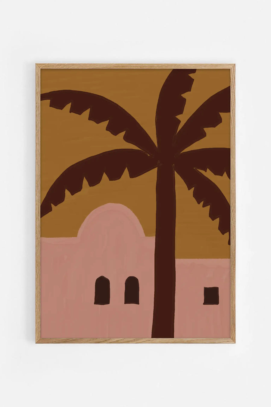 Fine art poster of a silhouetted palm tree against a golden sky above a pink desert building with arched windows.